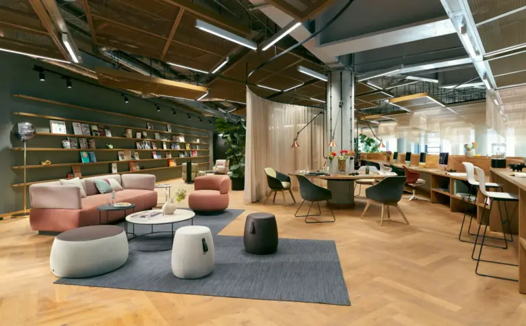 Contemporary workplace with collaborative seating, meeting areas, integrated planting and flexible work settings.