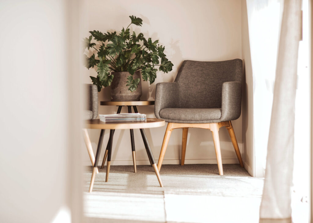 Buro chair displayed beside a small table and indoor planting in the ACCO showroom.