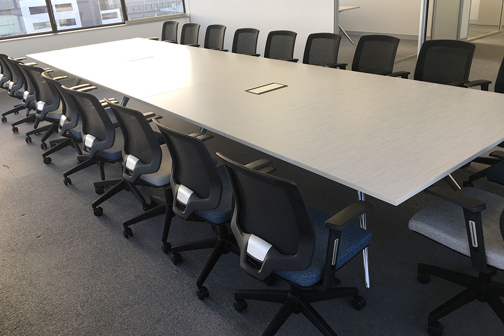 Large meeting table and office chairs at Diplomat Global