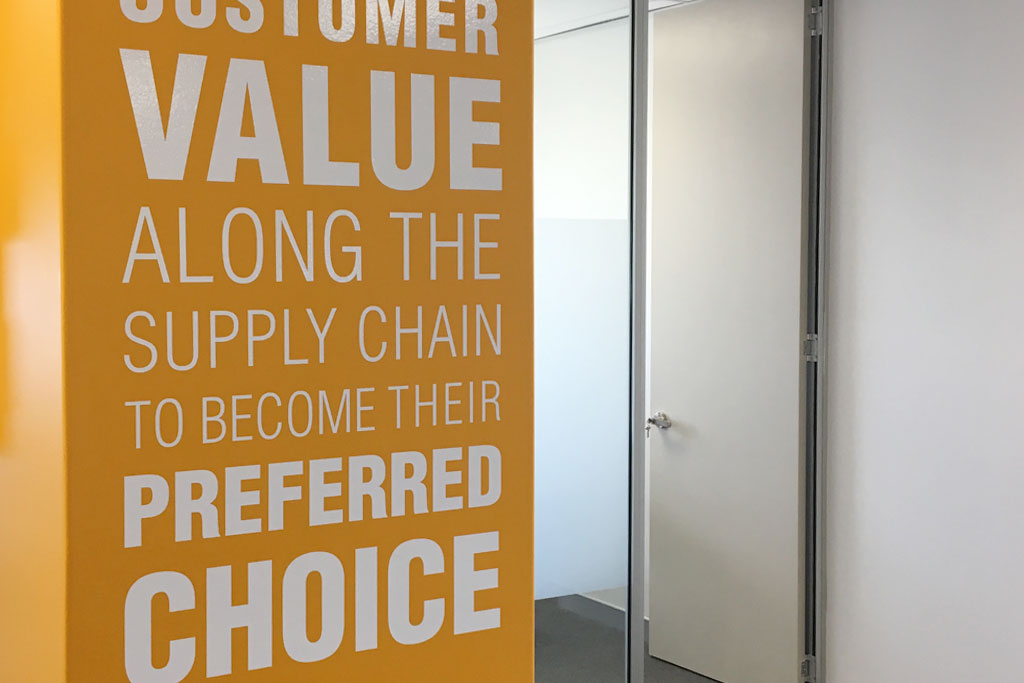 Diplomat Global company values displayed on branded wall graphics