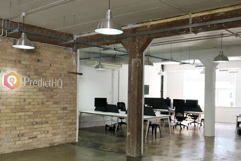 PredictHQ office with exposed brick and original structural details